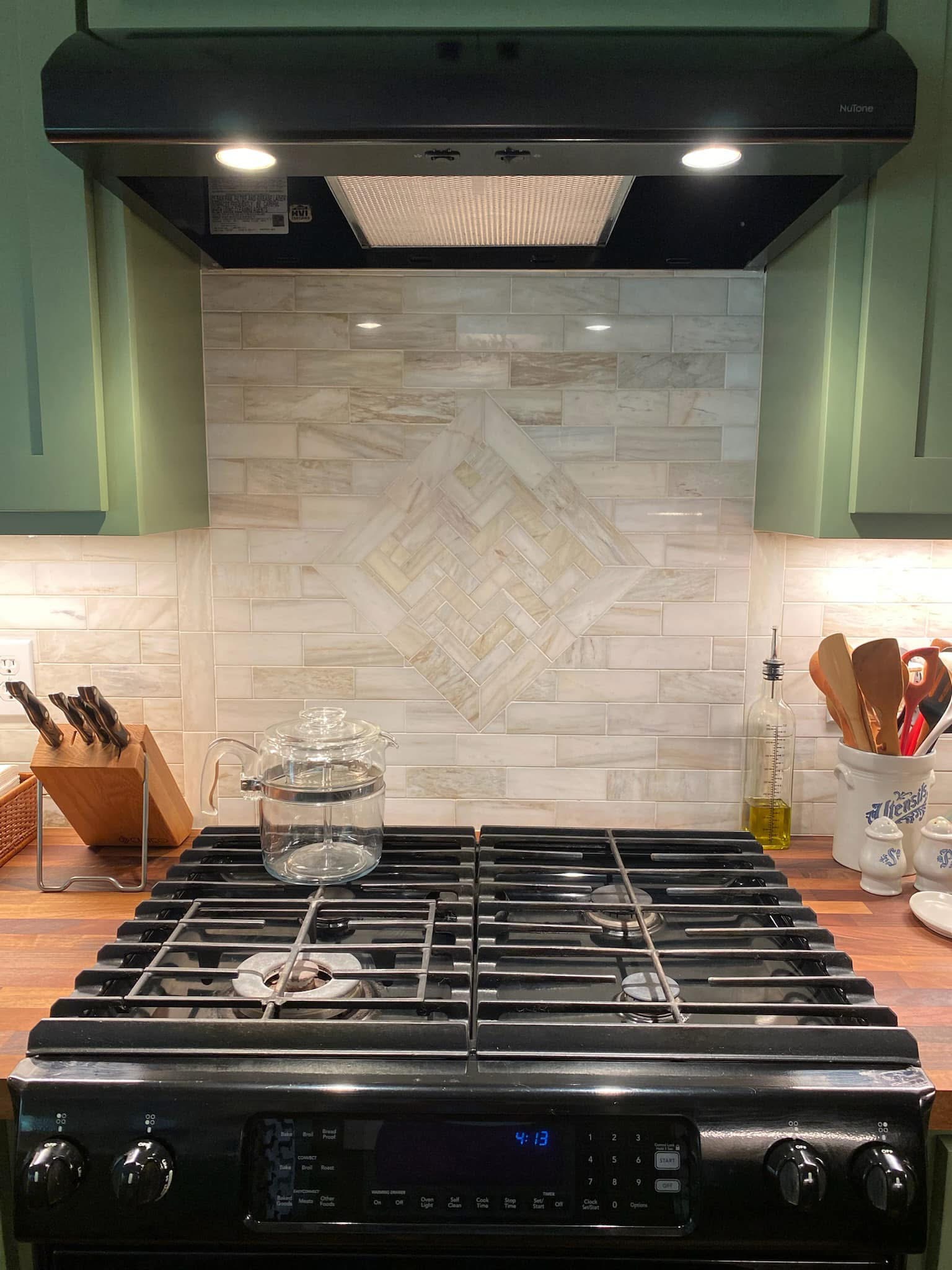 Herringbone tile detail above the kitchen range
