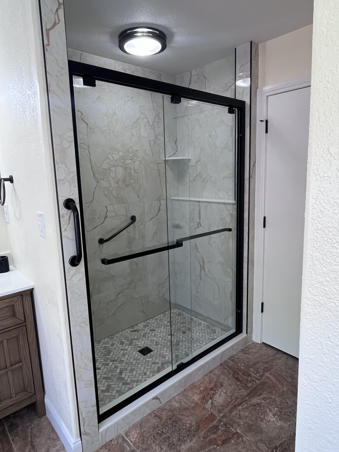 Glass shower enclosure with black frame