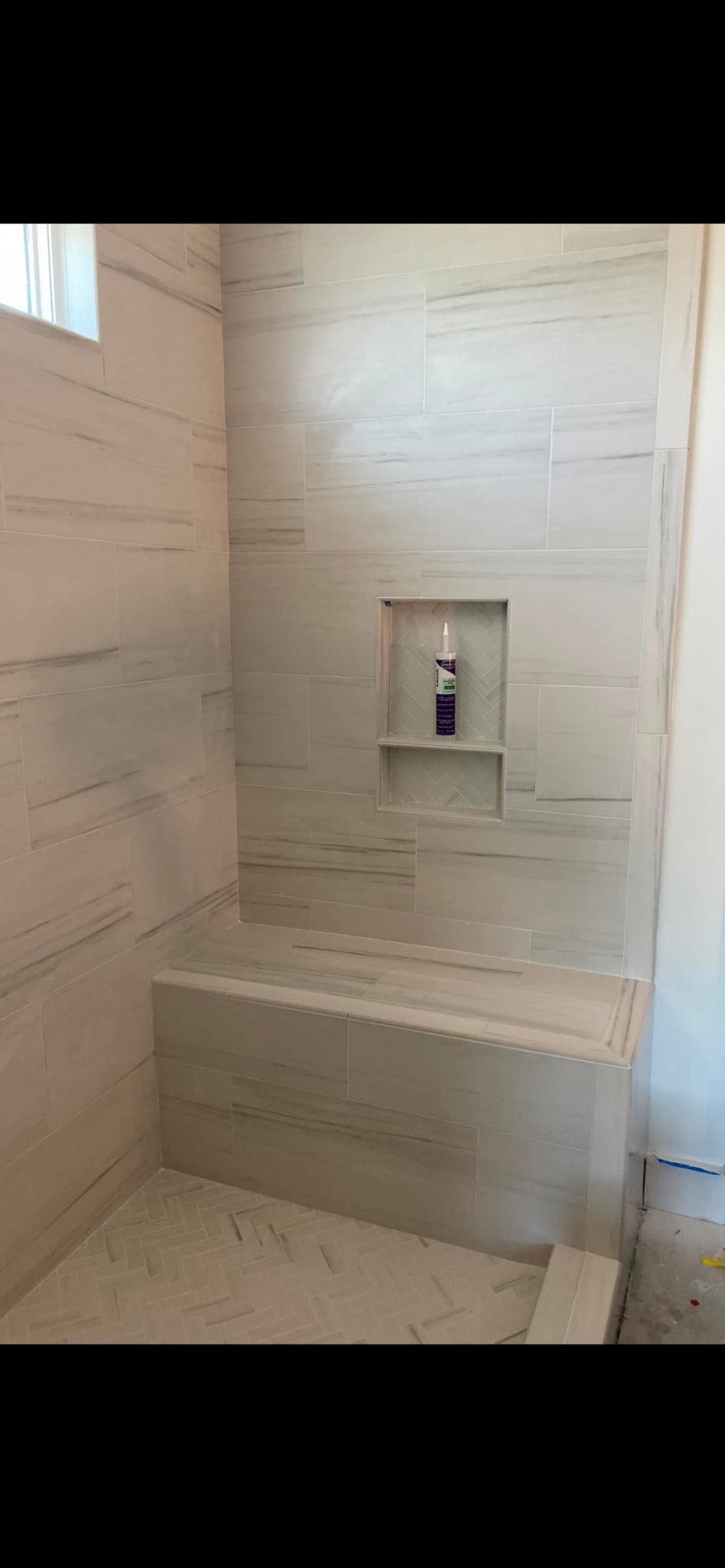 Tiled shower with built-in bench and niche