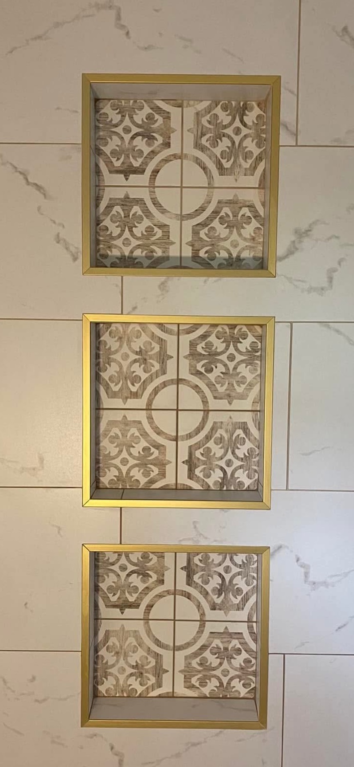 Three decorative shower niches with gold trim
