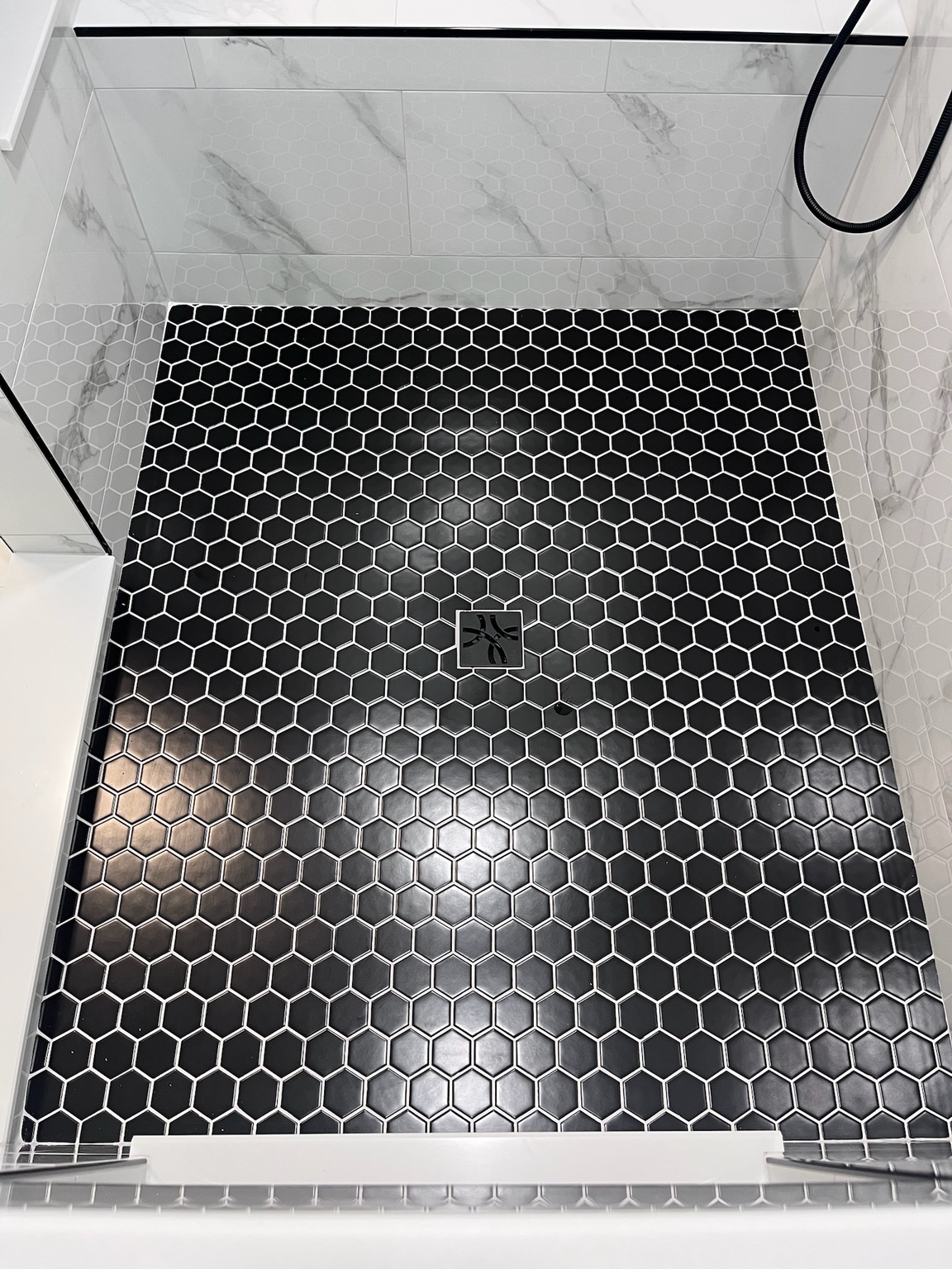 Dark hexagon mosaic shower floor