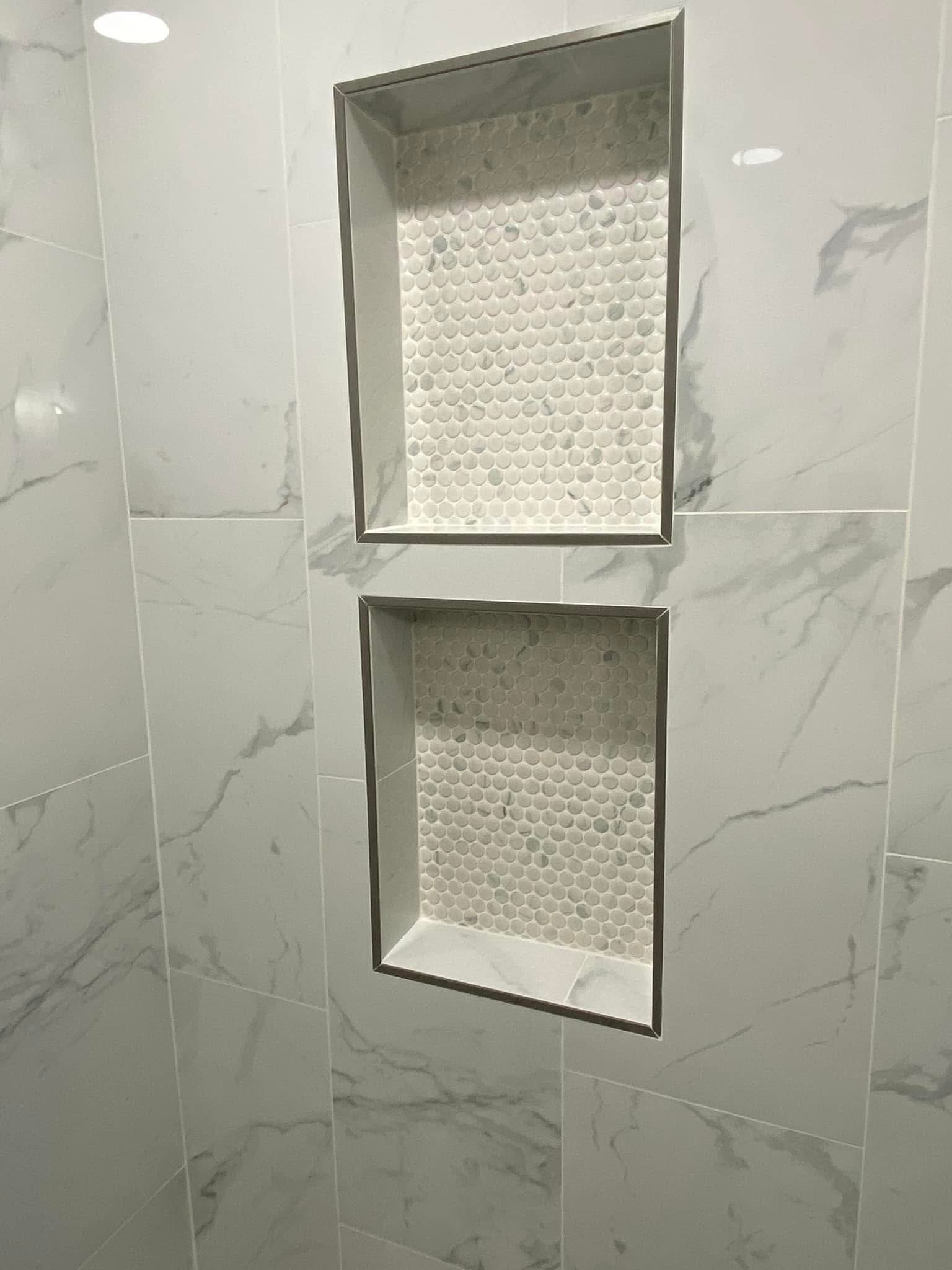 Two stacked shower niches in marble-look tile