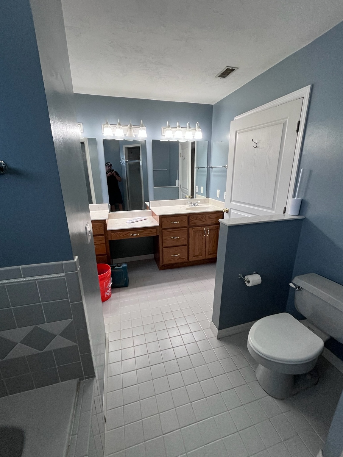 Bass family bathroom before renovation, showing the original vanity and tile floor