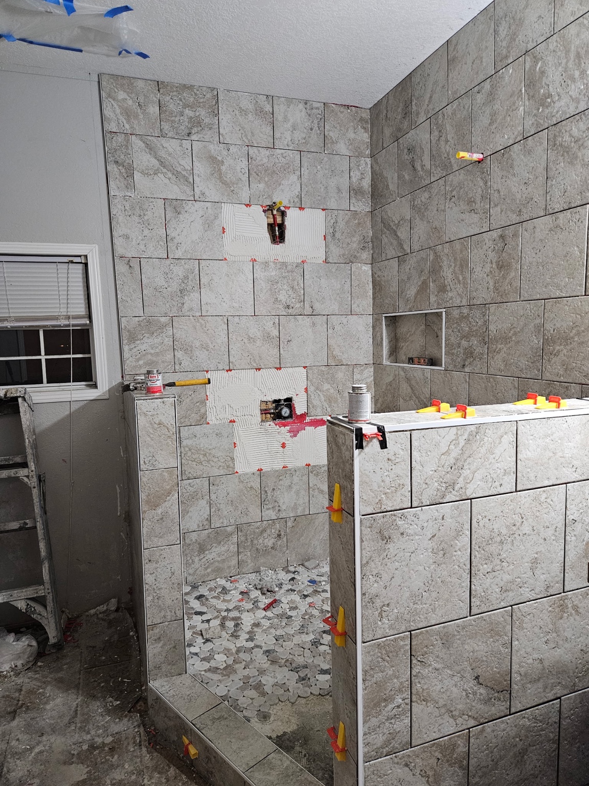 Shawna’s earlier gray tiled shower during inspection and repair